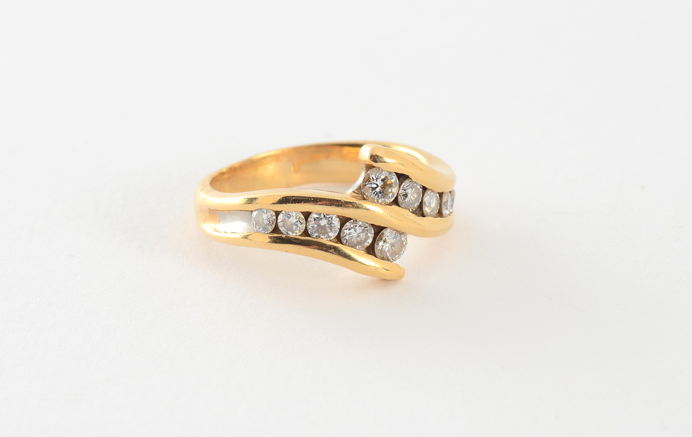 Appraisal: K AND PLATINUM DIAMOND BYPASS RING K yellow gold with