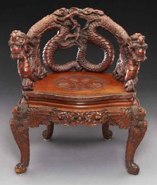 Appraisal: Japanese hardwood carved armchairthe highly carved pierced back featuring entwined