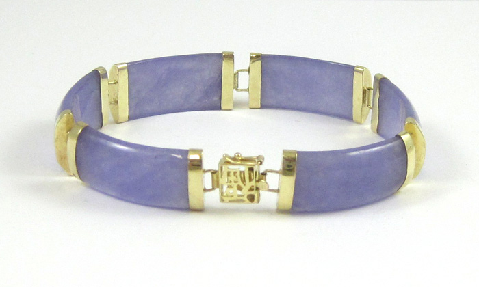 Appraisal: LAVENDER JADE AN FOURTEEN KARAT GOLD BRACELET with six curved