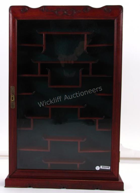 Appraisal: An Oriental style wall curio cabinet with approximately shelves brass