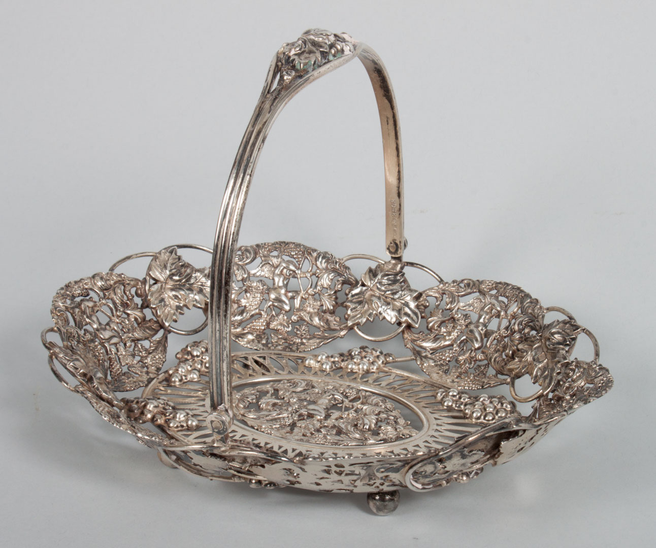 Appraisal: JE Caldwell cast sterling silver basket with grape cupid motif