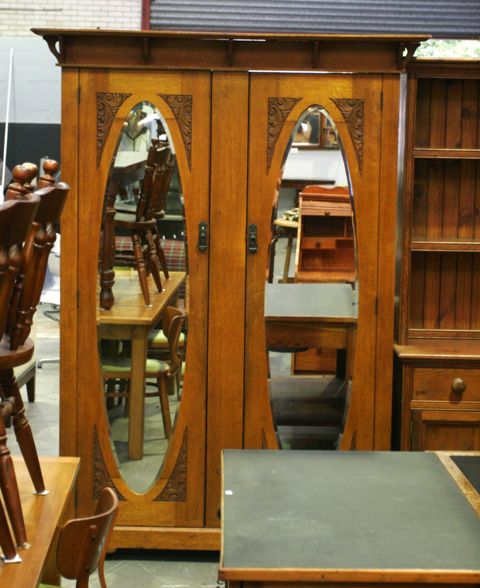 Appraisal: An arts and crafts style stained maple two door wardrobe