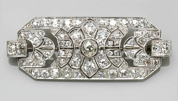 Appraisal: An art deco diamond and platinum filigree brooch estimated total