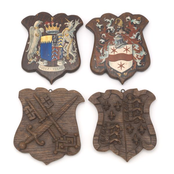 Appraisal: FOUR VICTORIAN CARVED WOOD AND PAINTED ARMORIAL SHIELDS Including carved