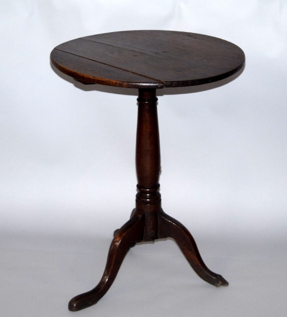 Appraisal: A George III oak occasional table the circular top raised