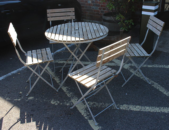 Appraisal: A CIRCULAR GARDEN TABLE with slatted top and wrought iron