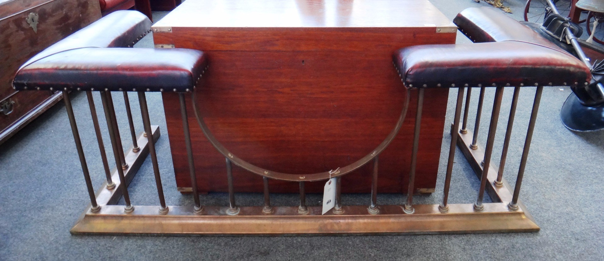 Appraisal: An English brass club fender early th century re-upholstered in