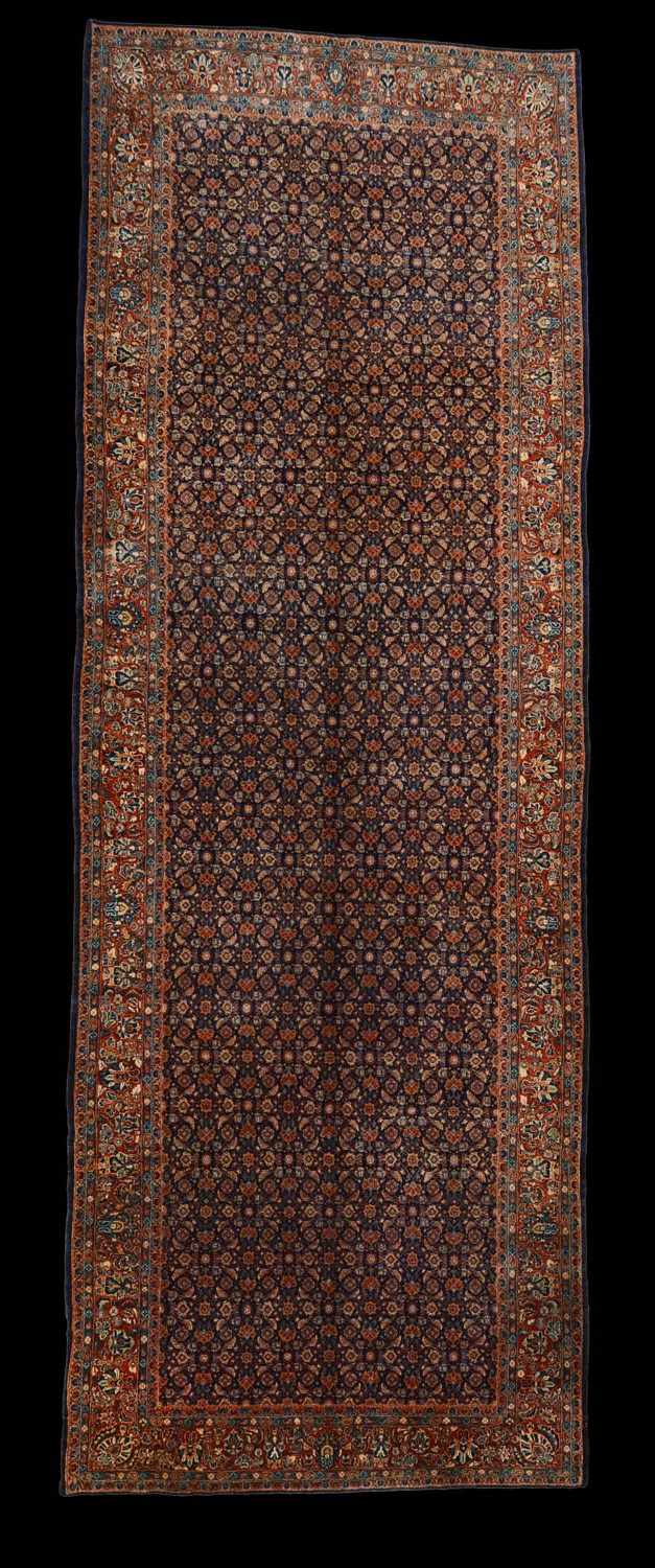 Appraisal: PERSIAN FERAGHAN CARPET The dark blue field with floral trellis