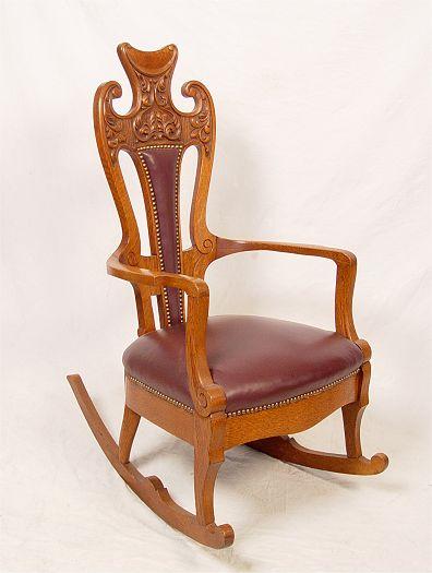 Appraisal: LATE VICTORIAN GOLDEN OAK CARVED ROCKER Richly carved crest newer