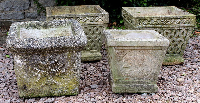 Appraisal: TWO COMPOSITE STONE SQUARE GARDEN URNS each with lattice decoration