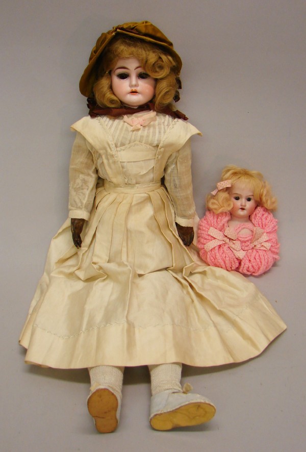 Appraisal: Pair of dolls L W C bisque shoulderhead doll Brown