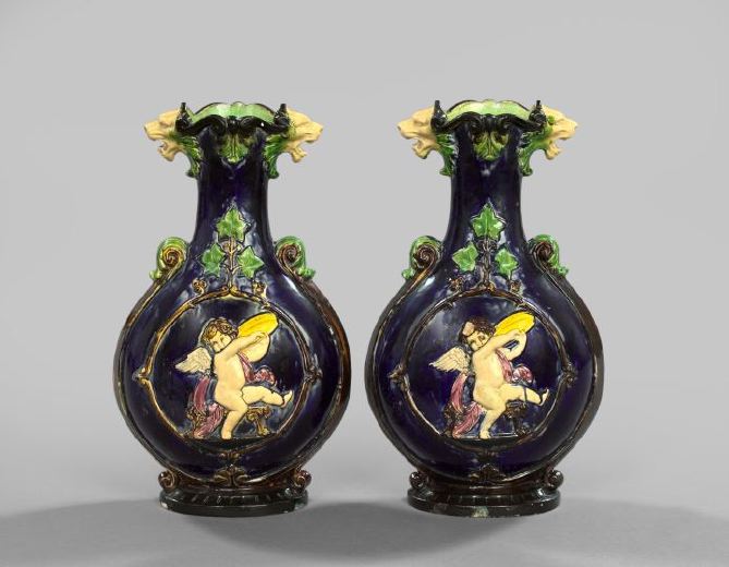 Appraisal: Pair of French Polychromed Majolica Garniture Vases in Musical Cherubim