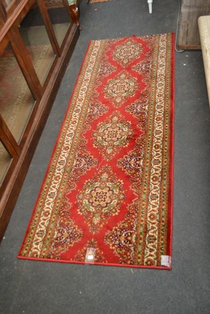 Appraisal: A RED WOOLEN RUNNER