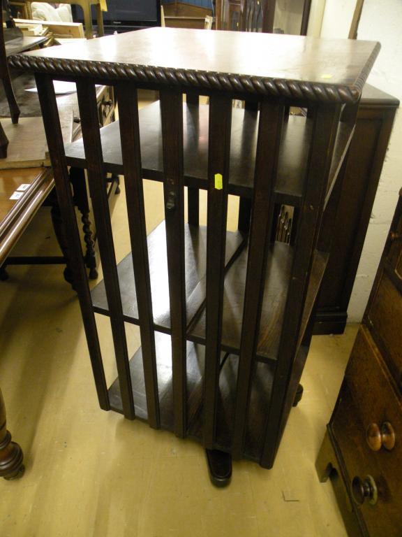 Appraisal: An oak revolving bookcase with a carved border