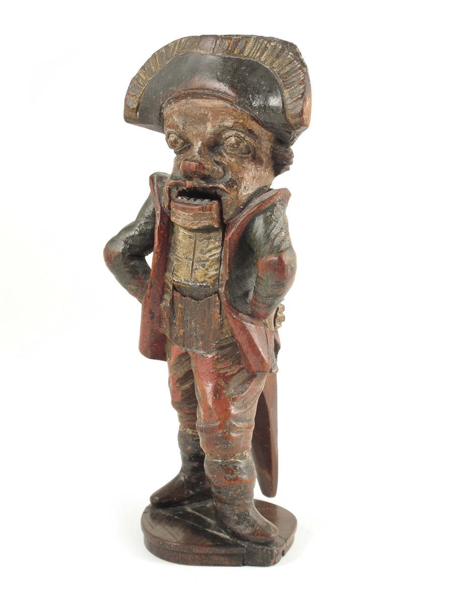 Appraisal: A German carved wood and polychrome decorated figural nutcracker