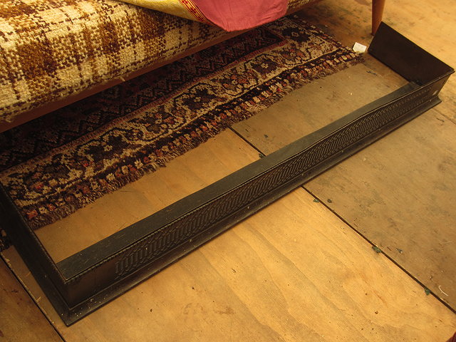 Appraisal: A GEORGIAN PIERCED STEEL FENDER cm in length together with