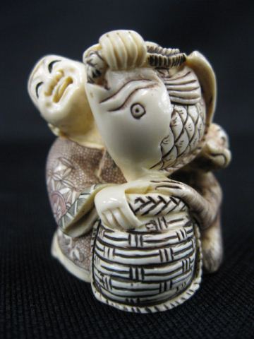 Appraisal: Carved Ivory Netsuke of Seated Manwith basket monkey and a