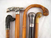 Appraisal: Five walking sticks comprising a Chinese dragon white metal Tau