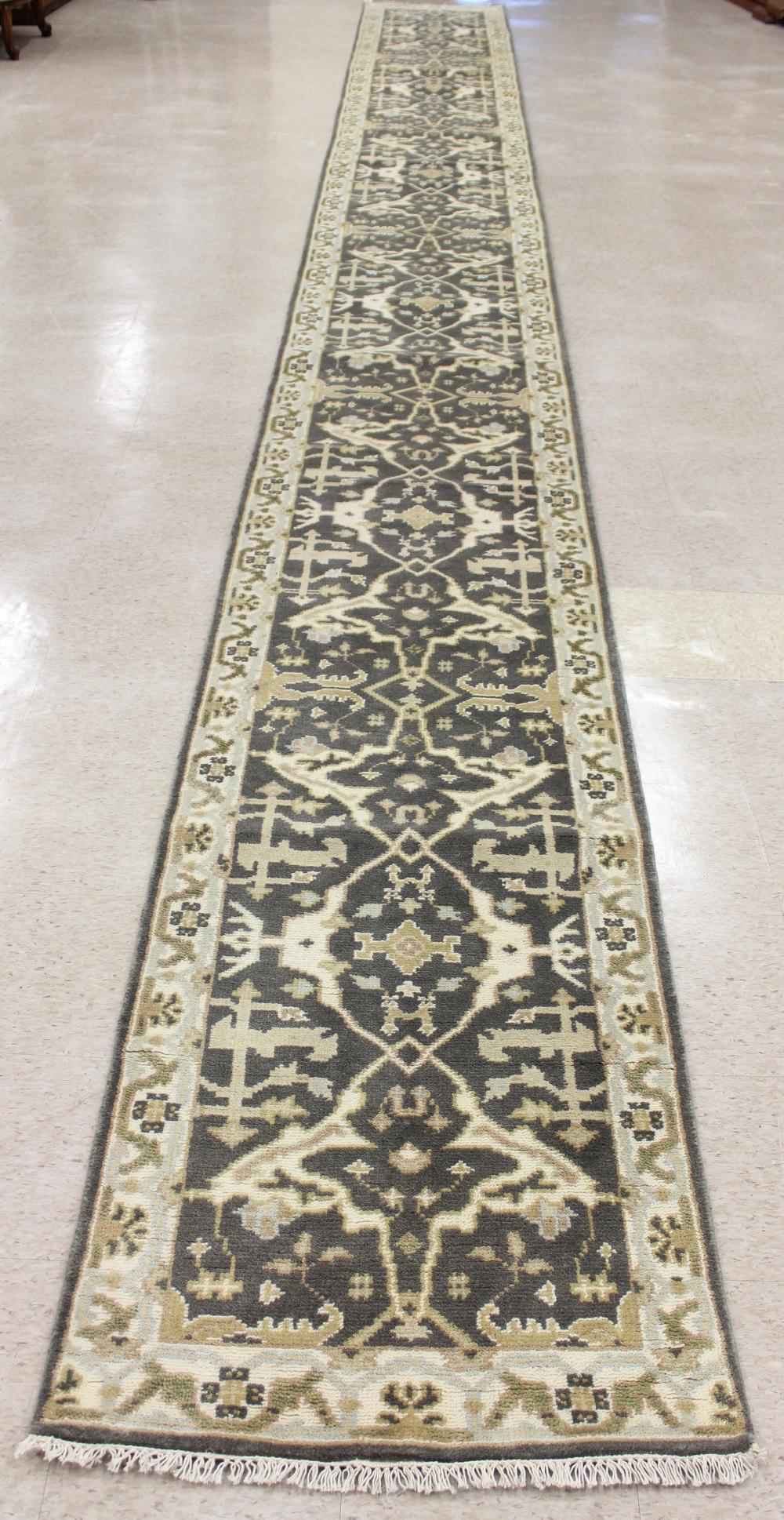 Appraisal: HAND KNOTTED ORIENTAL LONG RUG Indo-Persian overall floral design on