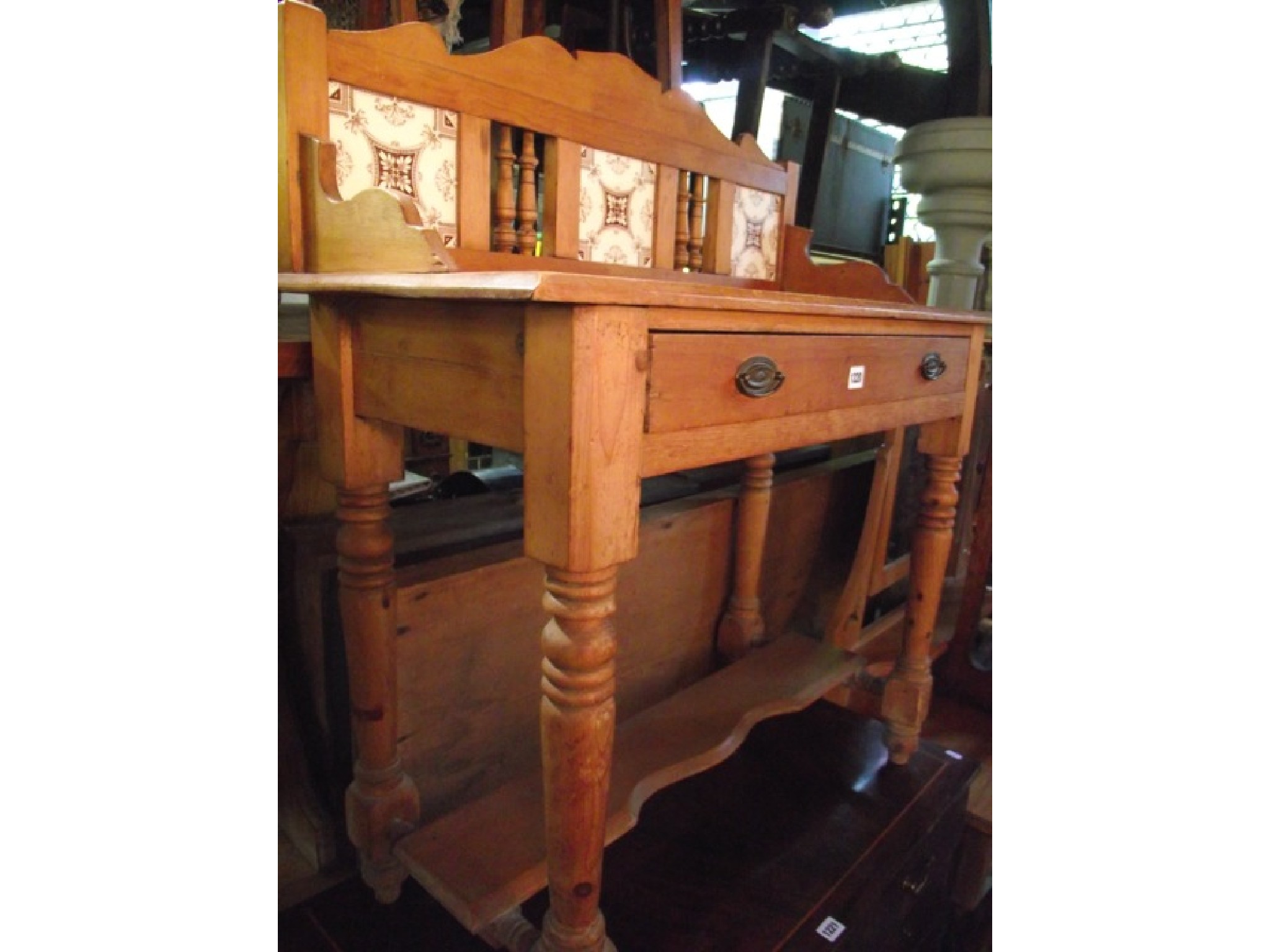 Appraisal: A late Victorian stripped pine washstand the raised back incorporating