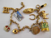 Appraisal: A carat gold charm bracelet with mixed and carat gold