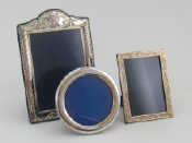 Appraisal: Three silver photo frames a circular with strut back cm