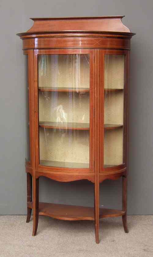 Appraisal: An Edwardian mahogany bow-front display cabinet the top with low