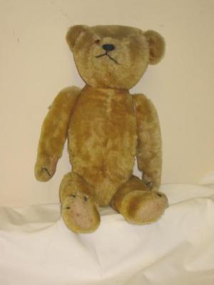 Appraisal: A gold plush articulated teddy bear with stitched muzzle and