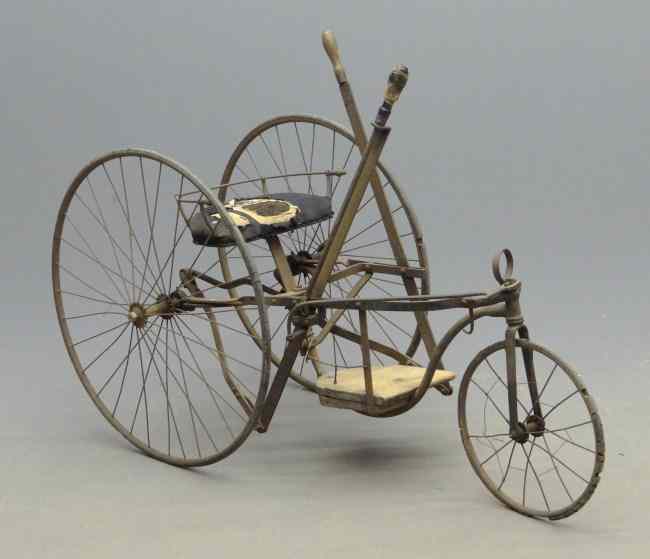 Appraisal: Early tricycle velocipede with hand driver levers which also steer