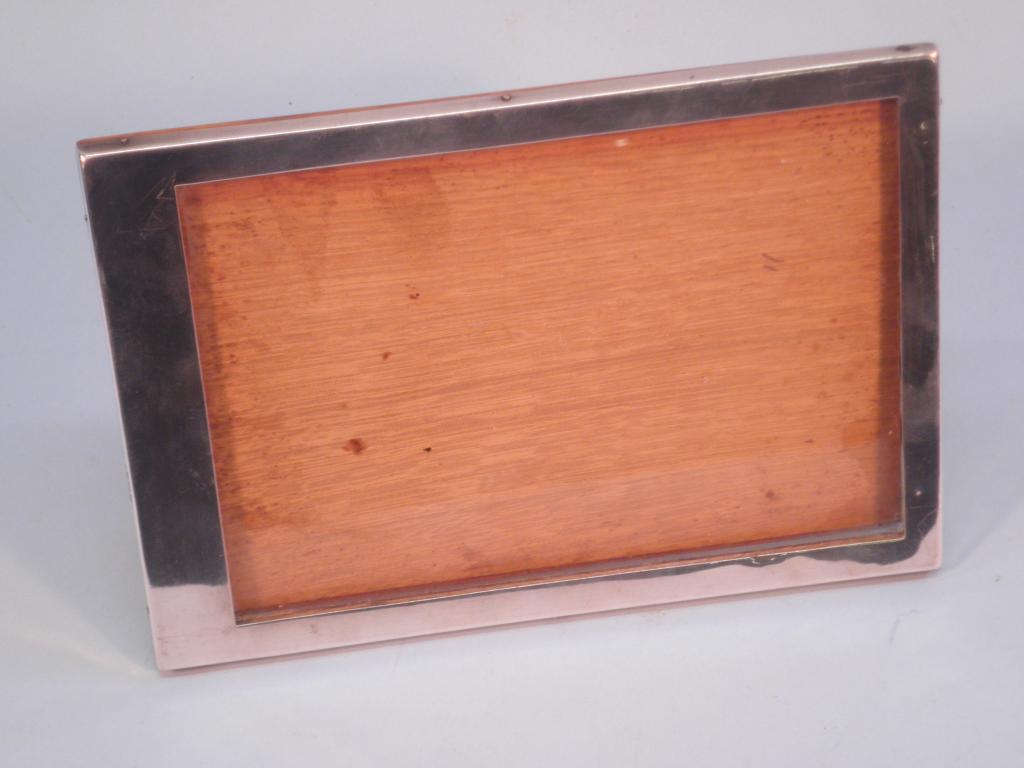 Appraisal: A rectangular silver and oak photograph frame cm x cm