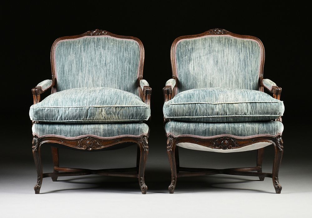 Appraisal: A PAIR OF LOUIS XV STYLE CARVED WALNUT FAUTEUILS A