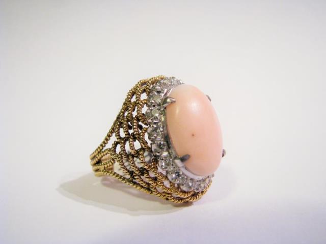 Appraisal: A K yellow gold ring with coral and eighteen round