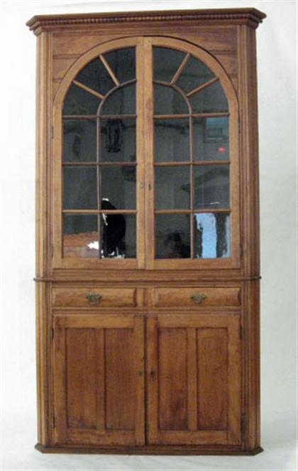 Appraisal: Cherrywood corner cupboard th century Molded and beaded cornice above