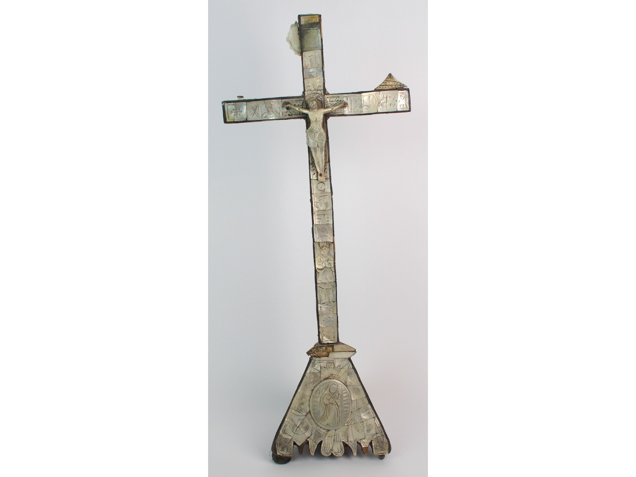 Appraisal: An th Century abalone shell crucifixengraved with IHS birds ladders