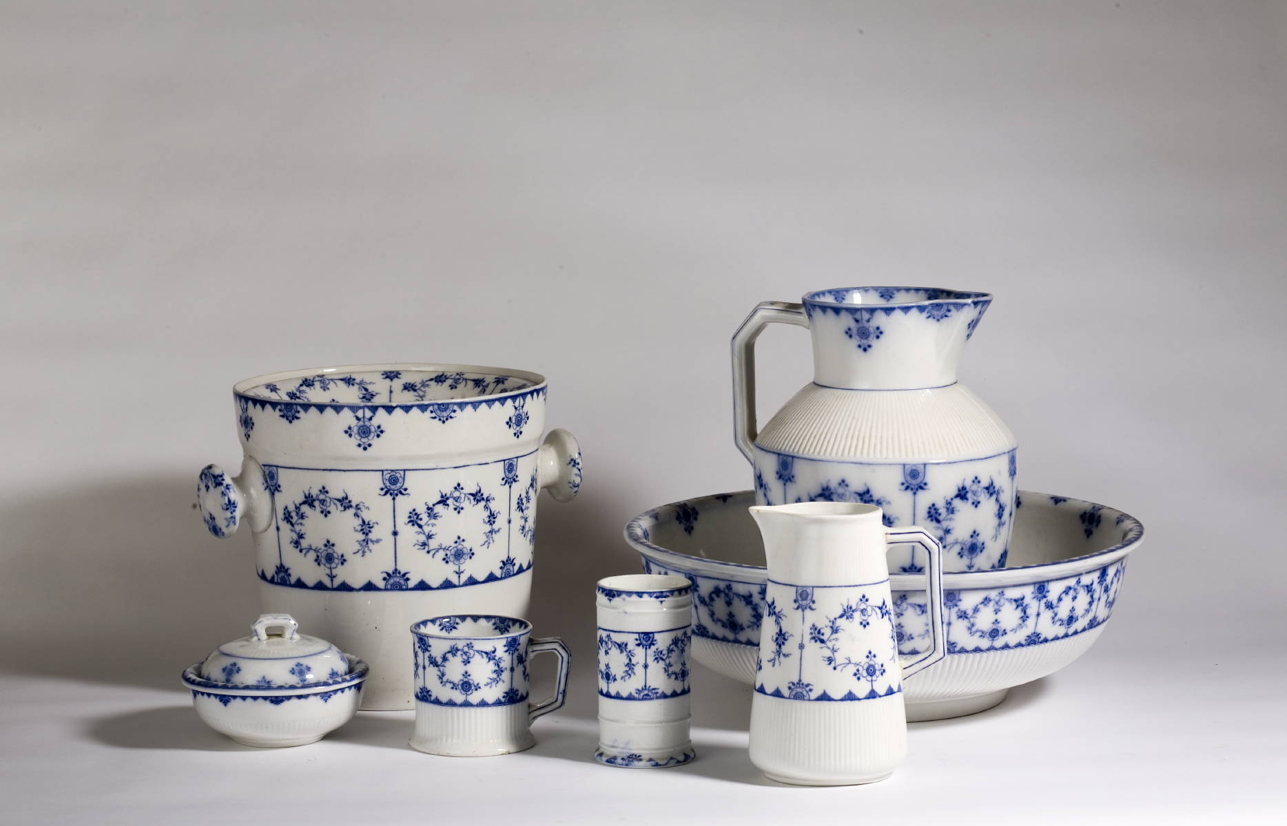 Appraisal: ENGLISH BLUE AND WHITE POTTERY CHAMBER SET COMPRISING A PITCHER