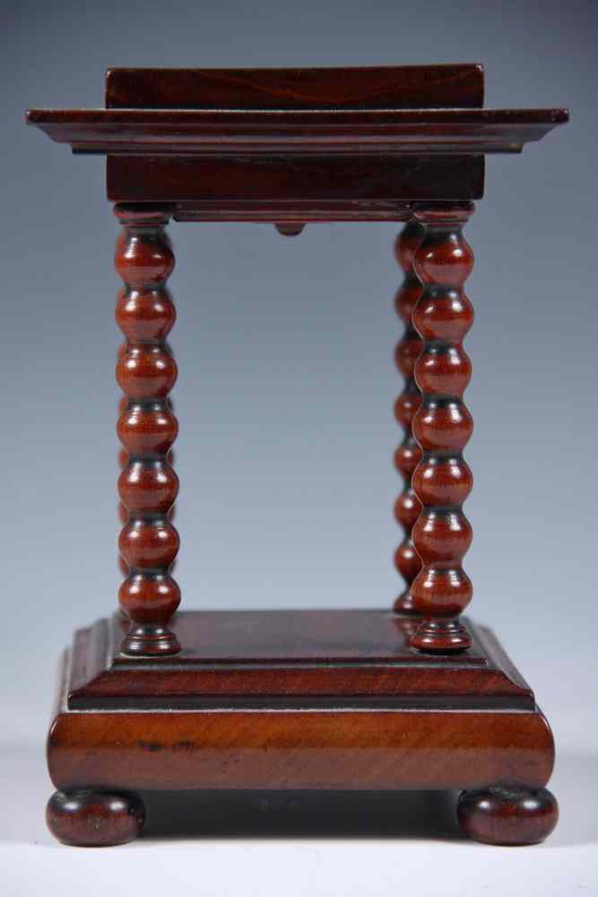 Appraisal: MINIATURE WALNUT BALDACCHINO FORM STAND-with turned pillar supports and bun