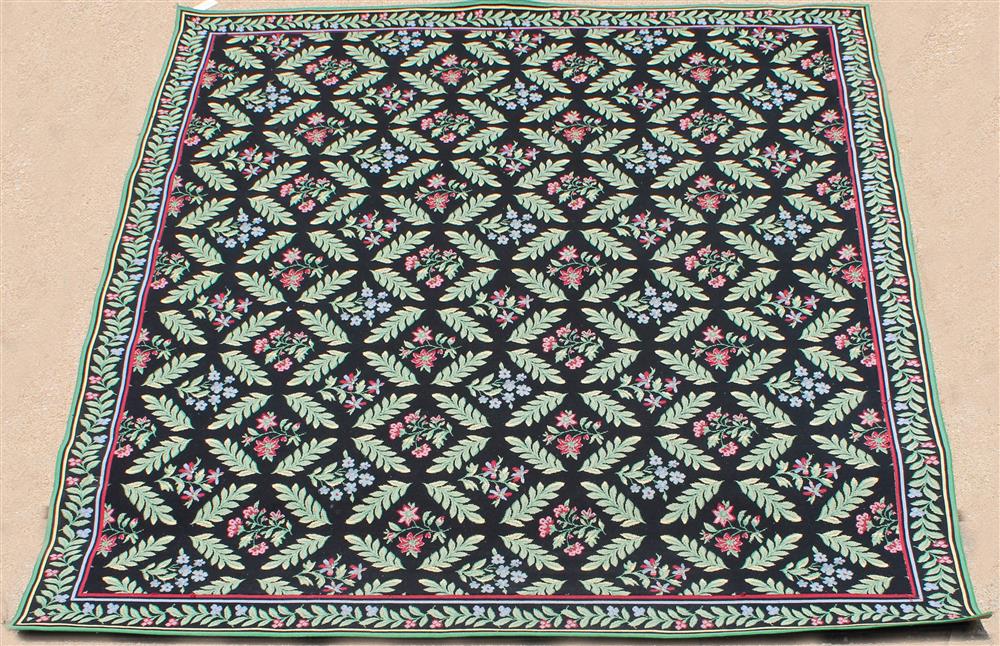 Appraisal: LARGE NEEDLEPOINT STYLE FLORAL RUG machine made black field with