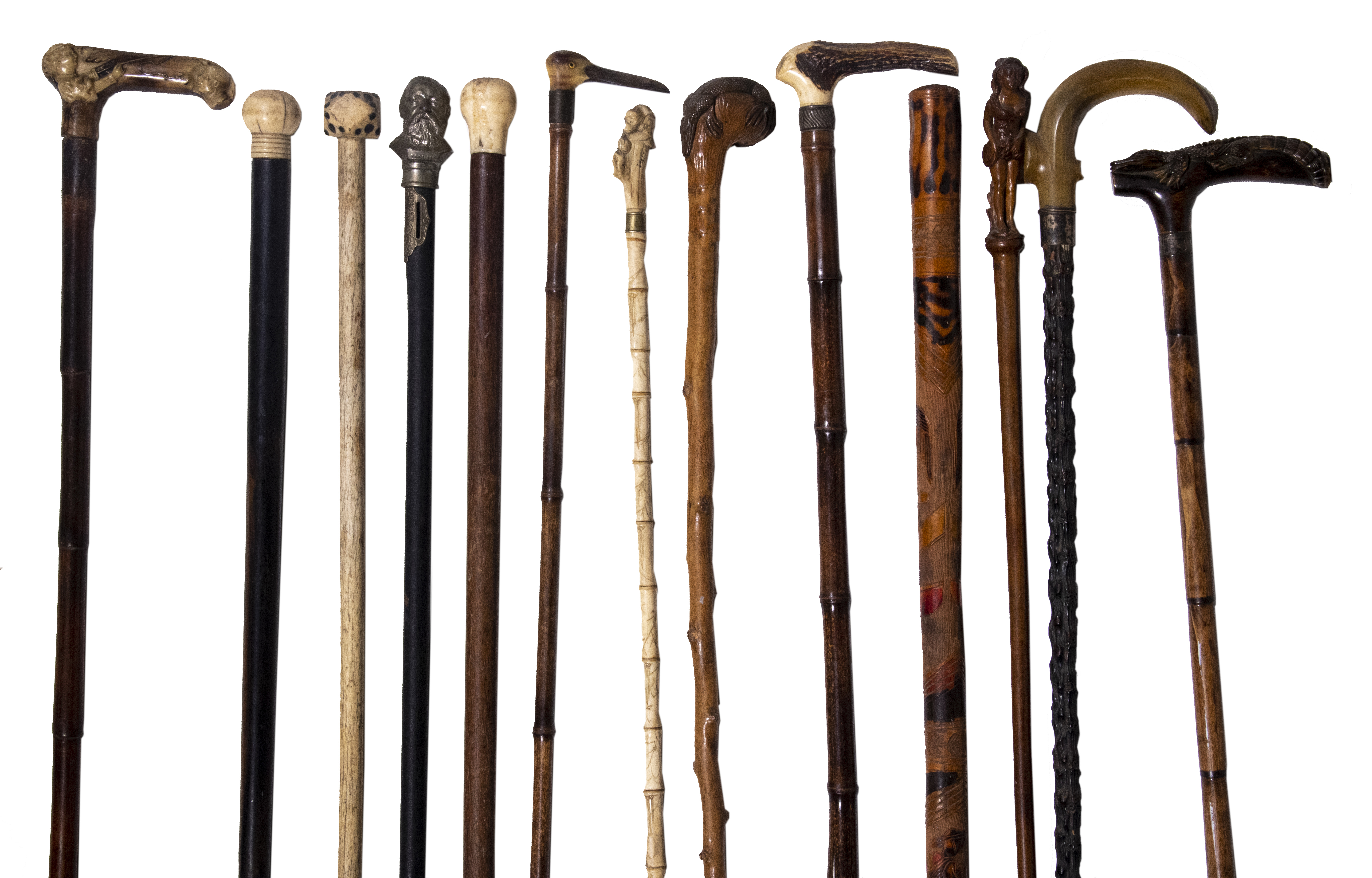 Appraisal: ANTIQUE WALKING STICKS Including Wooden stick topped with carved standing