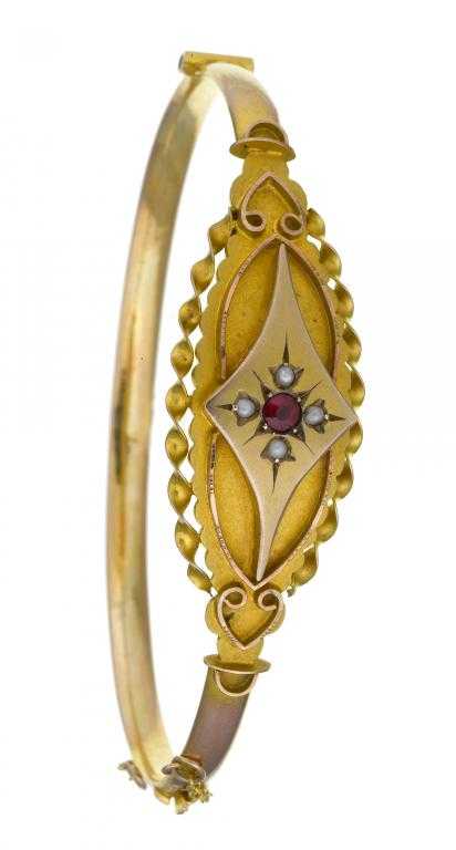 Appraisal: A GOLD BRACELET gypsy set with a central ruby surrounded