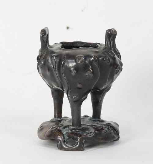 Appraisal: A Chinese bronze censer naturalistically cast and with loop handles