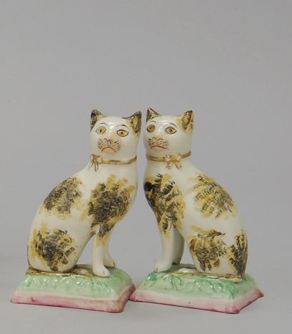 Appraisal: PAIR OF STAFFORDSHIRE FIGURES OF CATS Circa With yellow and