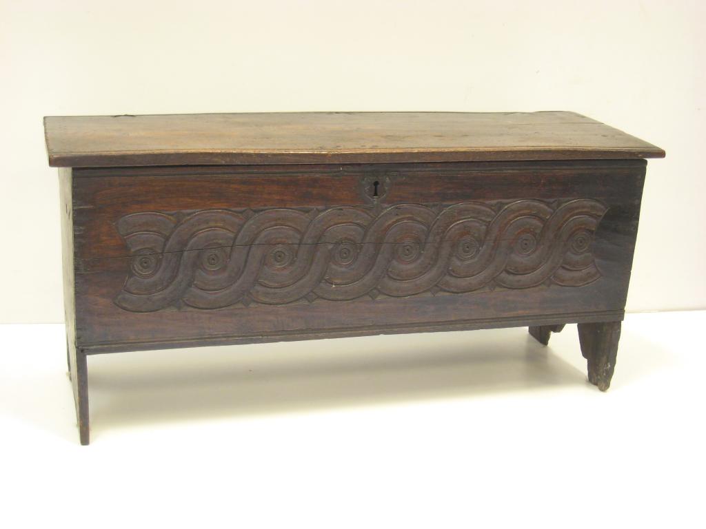 Appraisal: An antique oak four plank Coffer carved front in wide