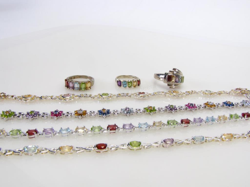 Appraisal: Seven multi-colored gemstone jewelry items including three rings and four