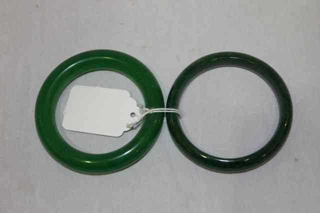 Appraisal: TWO SPINACH JADE BANGLES of plain form