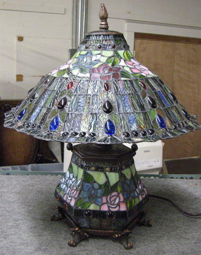 Appraisal: A STAINED AND LEADED GLASS TABLE LAMP in a floral