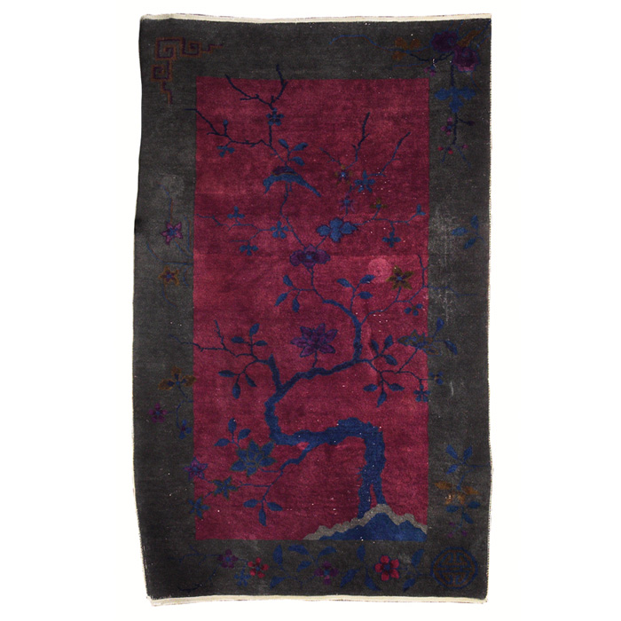 Appraisal: Chinese rug blossoming tree with a bird against a red