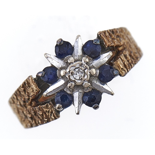 Appraisal: A sapphire and diamond cluster ring in textured ct gold