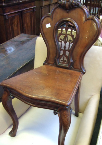 Appraisal: A th century mahogany hall chair with carved crest and