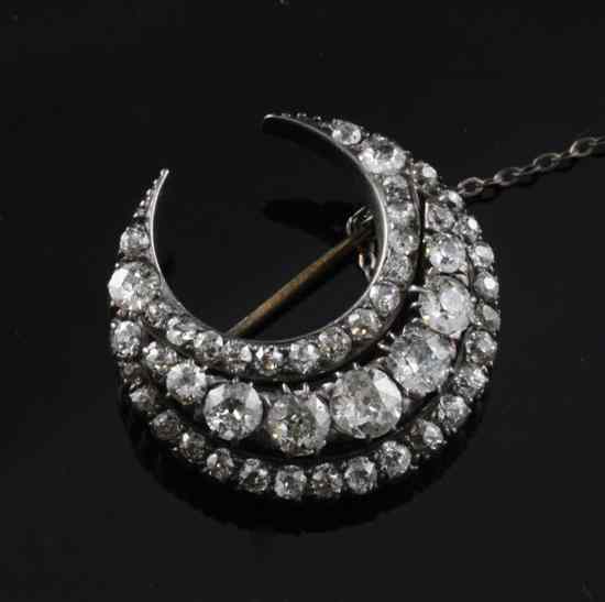 Appraisal: A late Victorian diamond set gold and silver crescent brooch