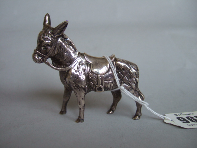 Appraisal: A silver model of a standing donkey with a saddle